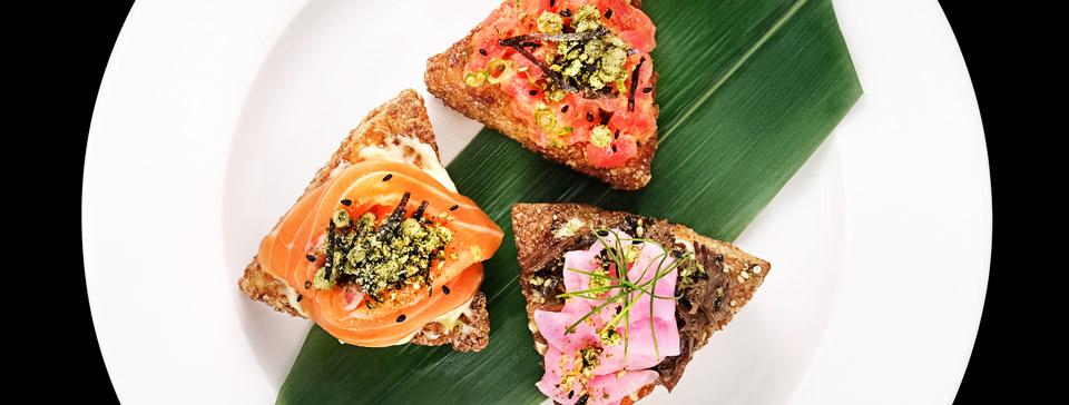 Salmon, tuna and a vegetable offering by Bessou atop fried rice cake